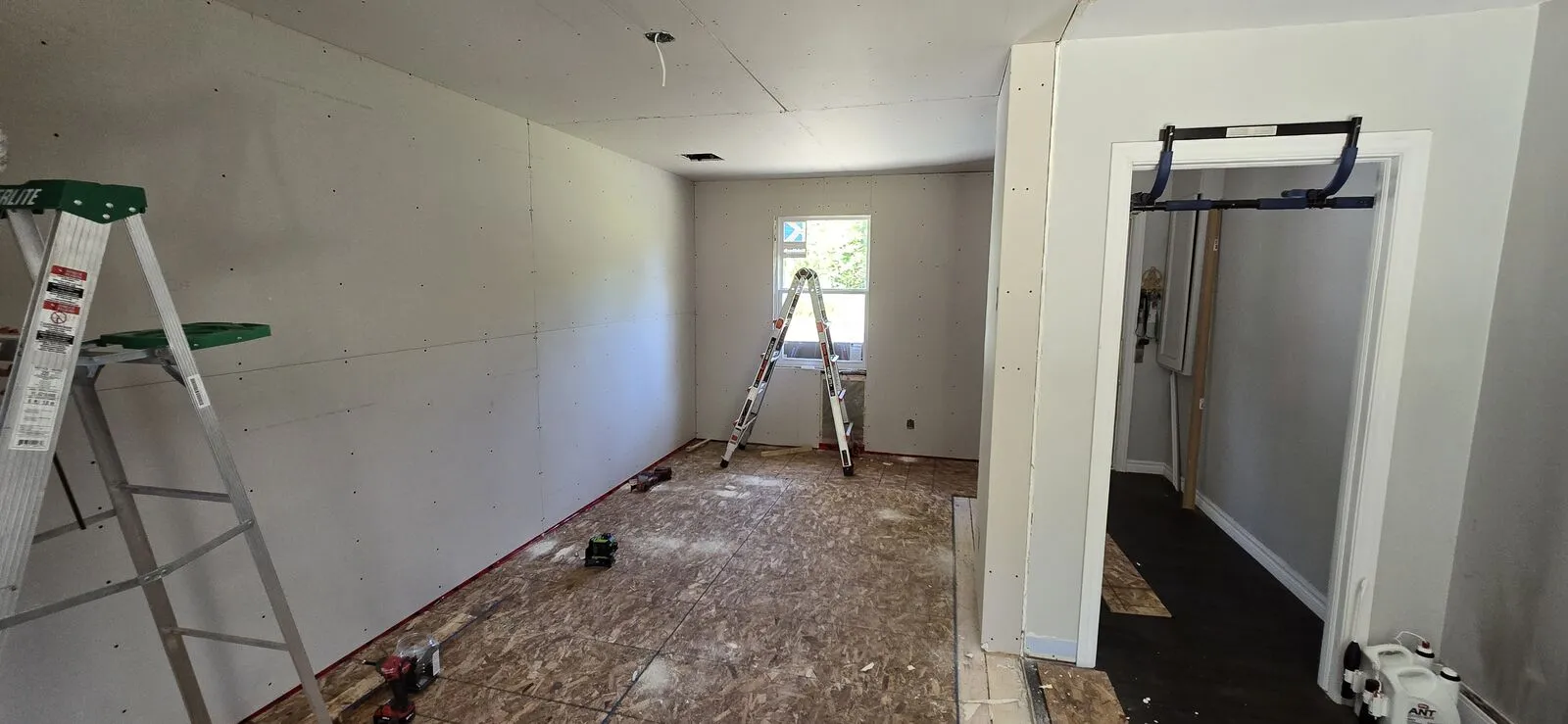Garage converted to a living space, with new siding — finished