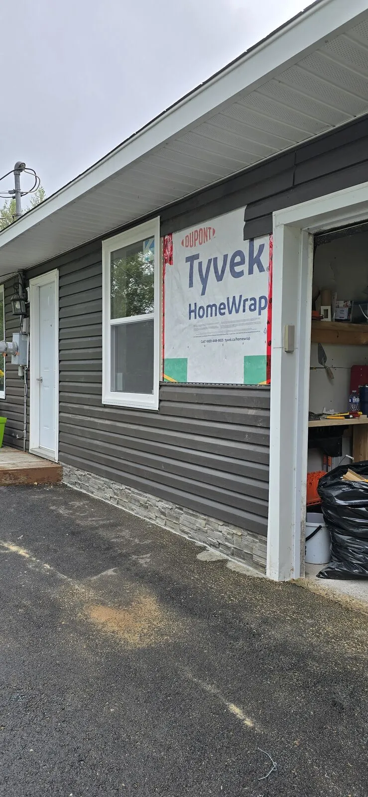Garage converted to a living space, with new siding — finished (4)