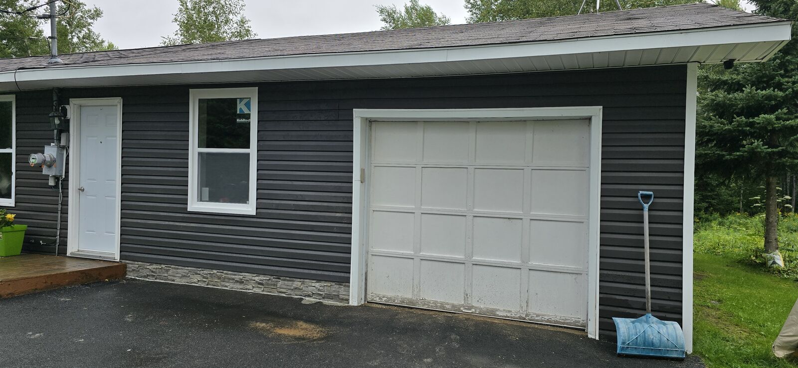 Garage converted to a living space, with new siding