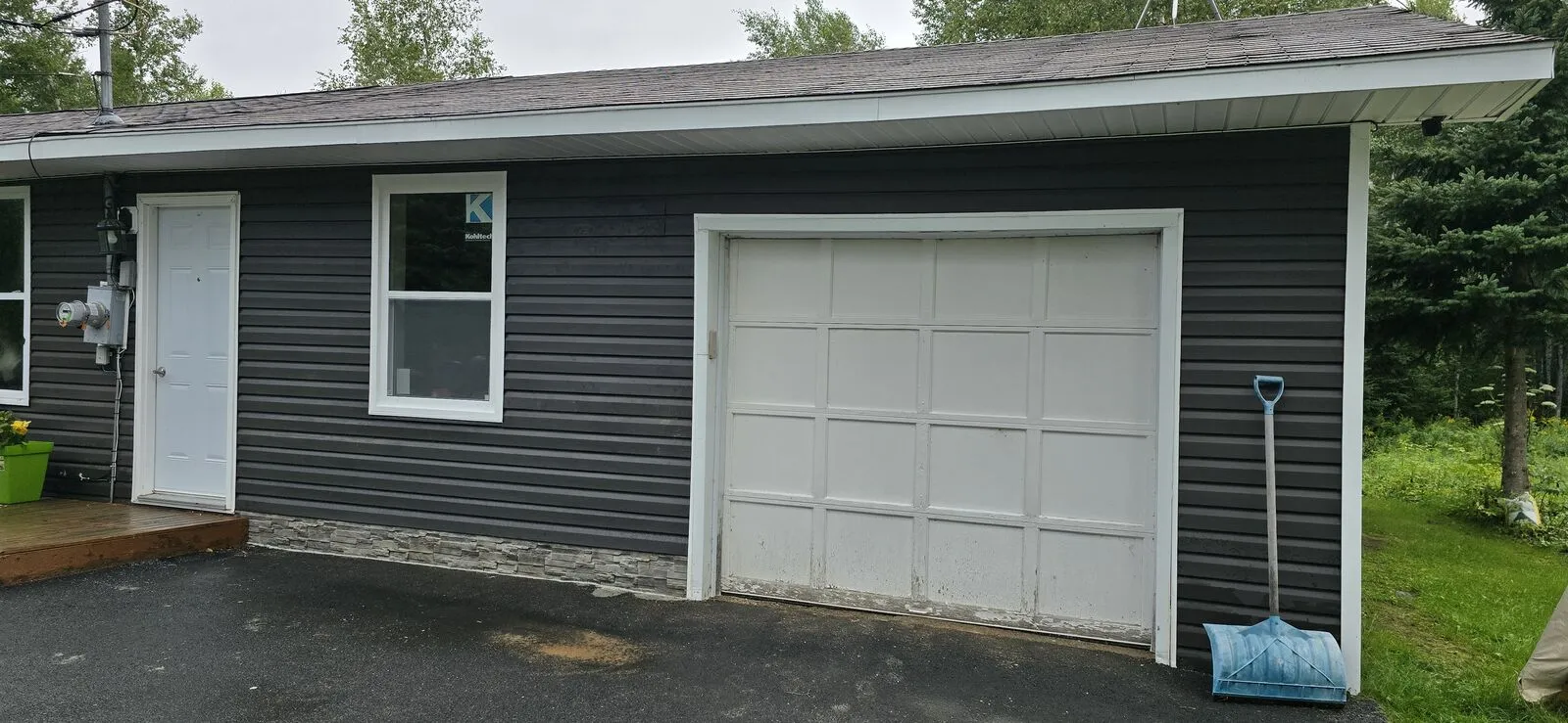 Garage converted to a living space, with new siding