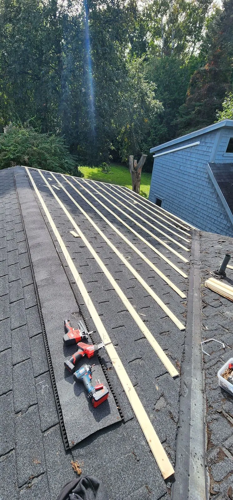 Metal roof over the old shingles — work in progress